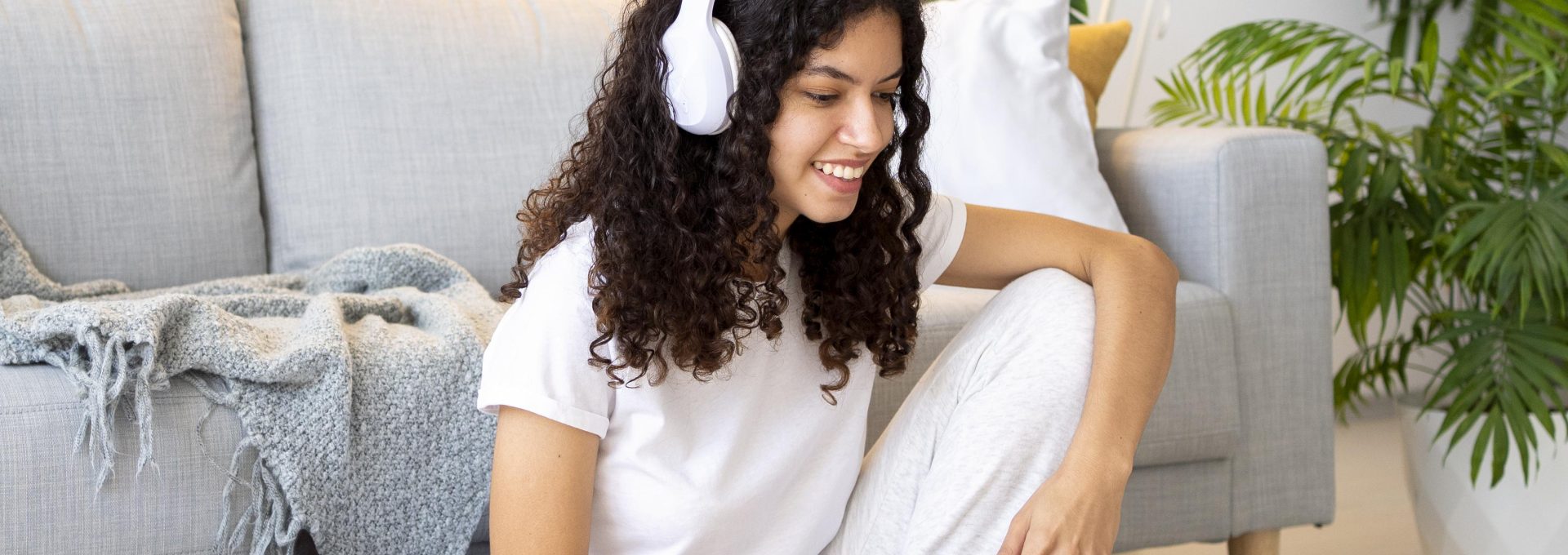a woman sitting on a couch next to a dog
